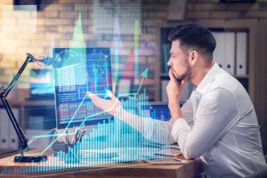 Illustration depicting a trader analyzing economic data on a computer screen, symbolizing the importance of staying informed about economic news and its impact on trading decisions.