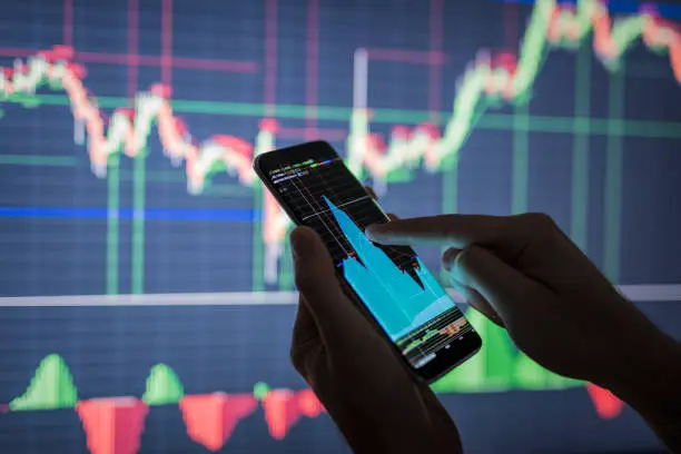 Image showing a trader analyzing risk management strategies on a computer screen, representing the importance of understanding and mitigating trading risks to protect capital and achieve long-term success in trading