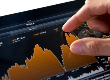 Image showing a stock market investor reviewing company reports and economic indicators, symbolizing the research and due diligence involved in fundamental analysis for making informed investment decisions.